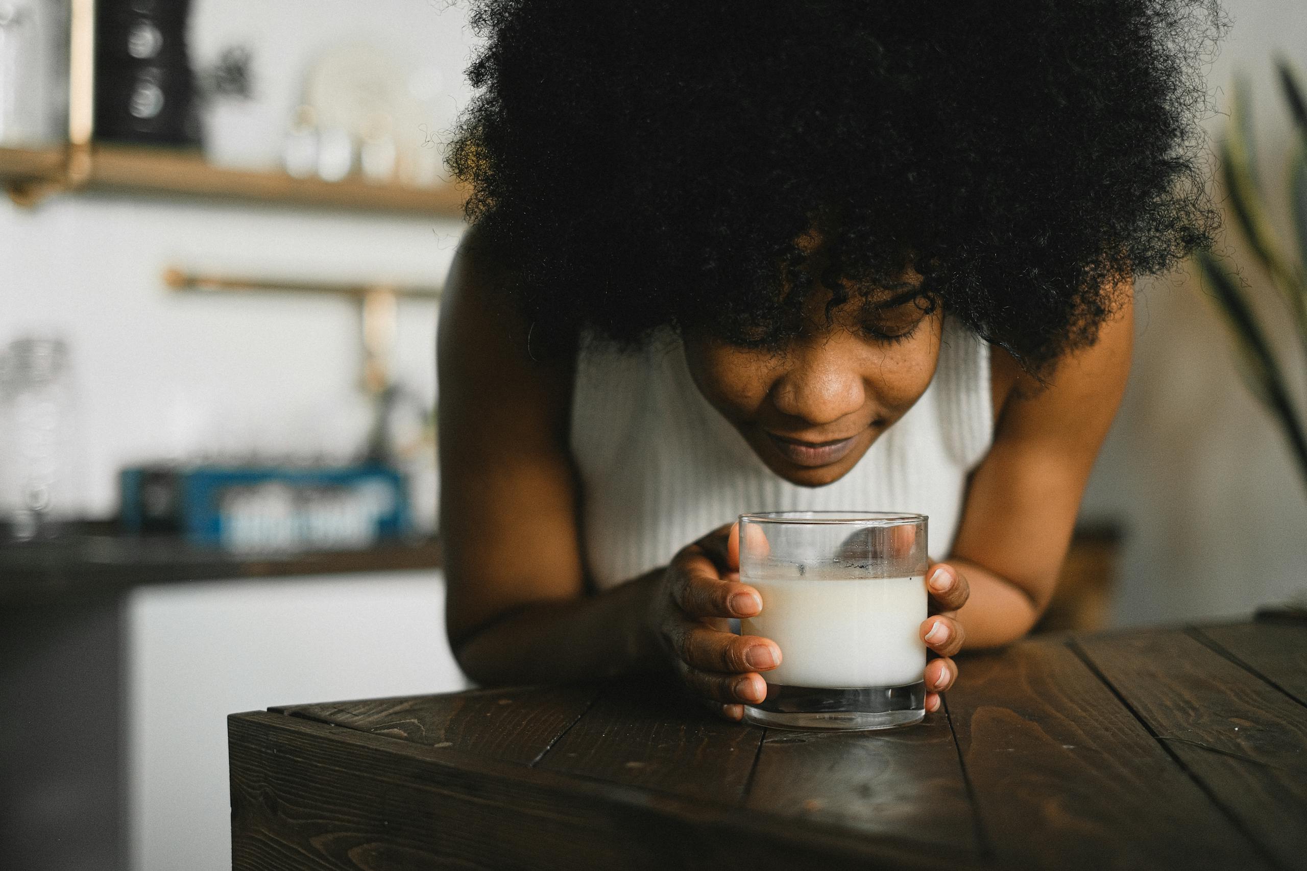 Peaceful female enjoying aromatic scent of Atelier Baldwin candle aromatherapy at home